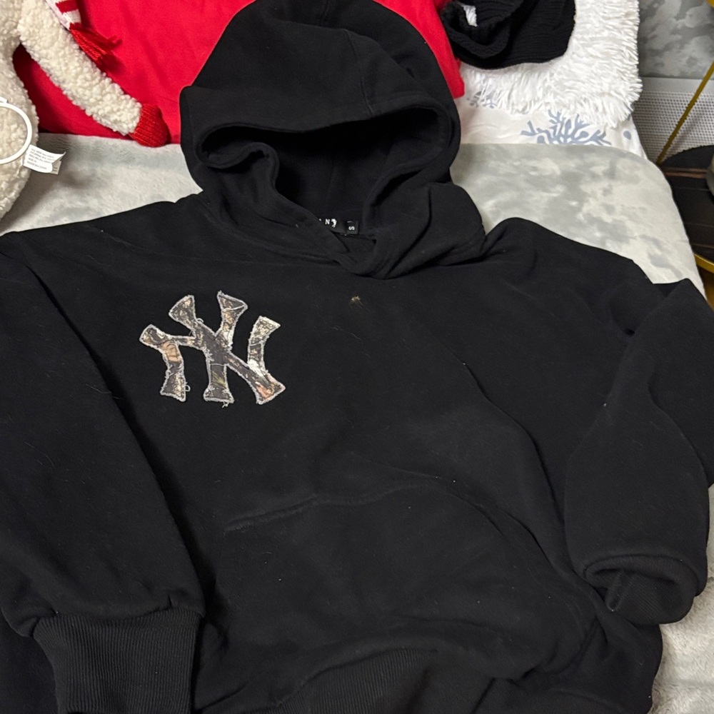 Stylish Black Hoodie with Distinctive Emblem